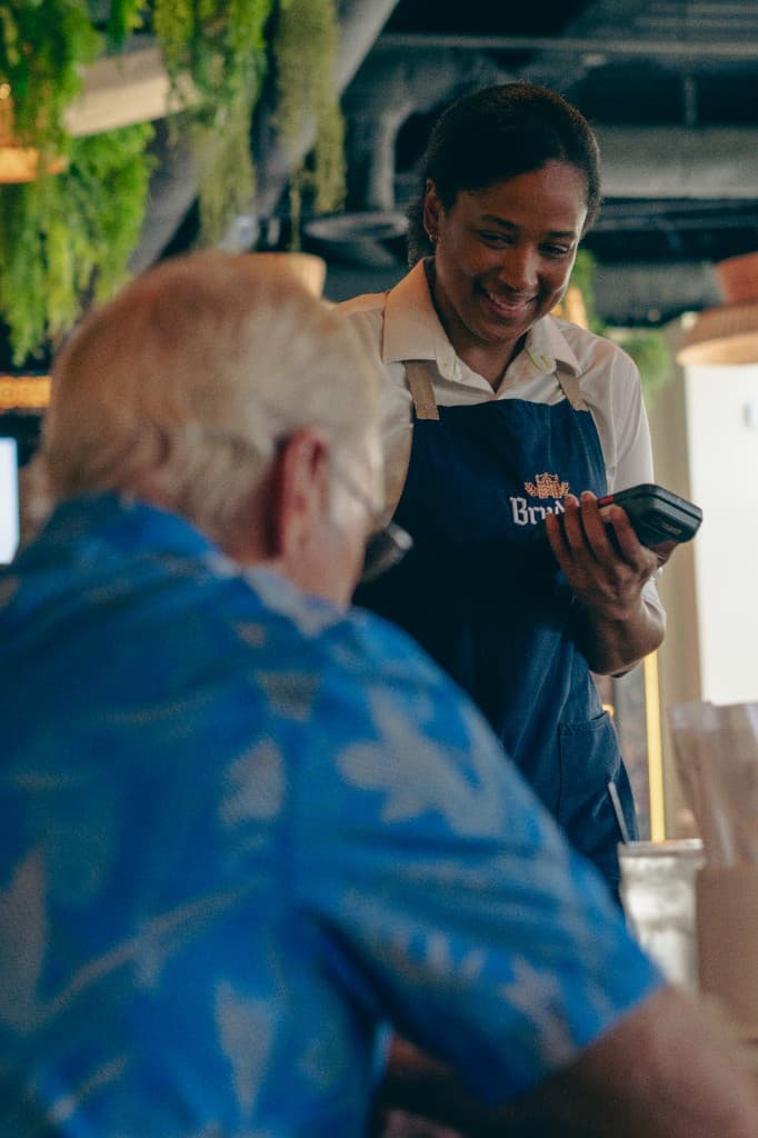 Bruder server assisting a guest at the table